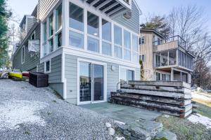 a house with glass doors and a staircase in front of it at Beautiful Berkshires Cottage on Lake Buel in Great Barrington