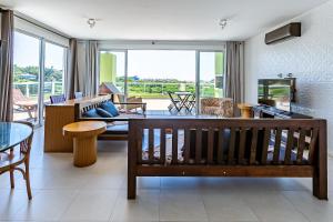 a living room with a couch and a table at Apto cobertura com vista p/ mar, Floripa ASR304 in Florianópolis