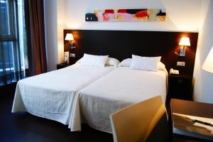 Postel nebo postele na pokoji v ubytování Hotel Sercotel Plana Parc