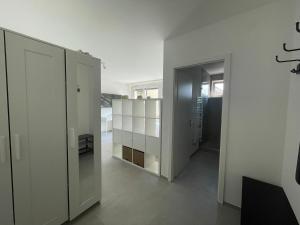 a room with white walls and a hallway at H95 Studios in Basel City with Basel Card in Basel
