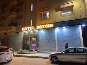 a man walking in front of a hotel sochi at Hotel Sotchi 