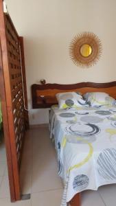 a bedroom with a bed and a mirror on the wall at Studio La villa du Manguier in Le Vauclin