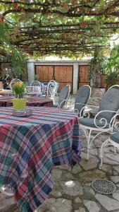 a patio with a table and chairs with a blanket at HeArt of Old Town Guesthouse in Podgorica