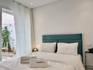 a bedroom with a large bed with two towels on it at Green Cocoon in Sidi Bou Saïd