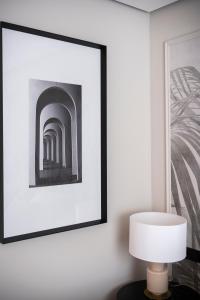 a picture frame on a wall with a lamp and a picture at YOU & CO. J. Botánico Boutique in Valencia