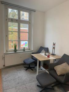 a room with two chairs and a table and a window at Altes Forstamt in Xanten