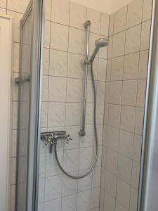 a shower with a hose in a bathroom at Altes Forstamt in Xanten