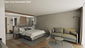 1 dormitorio con 1 cama y 1 sofá en Hotel Cendevaves, en Santa Cristina Valgardena