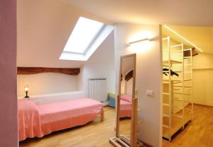 a bedroom with a bed and a skylight at SM Hospitality SANTO STEFANO in Reggio Emilia