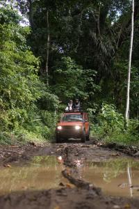 a car driving down a dirt road with two people on the roof at Java Turtle Lodge Meru Betiri in Banyuwangi