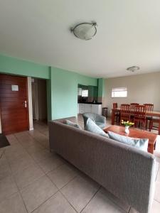 een woonkamer met een bank en een tafel bij The Oceanic Self Catering Apartment in Durban