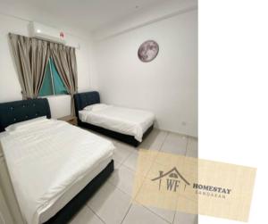 Voodi või voodid majutusasutuse WF Homestay Sandakan toas
