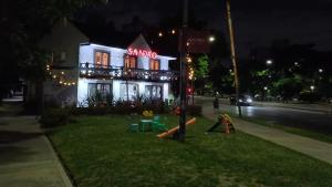 a house with a playground in front of it at night at Monoambiente en Duplex Velez Sarsfield in Buenos Aires