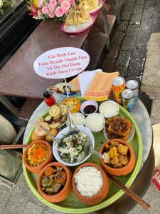 a tray of food on a table with rice and vegetables at Côn Đảo Xanh Hotel in Con Dao