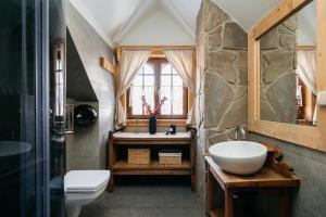 a bathroom with a sink and a toilet at Mountain Shelter by Loft Affair in Zakopane