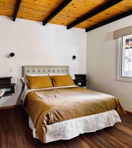 a bedroom with a large bed in a room at Departamento con parrilla in San Carlos de Bariloche