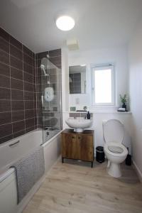 a bathroom with a toilet and a sink at City Apartment by the Castle, Free Parking. in Stirling