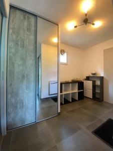 a large glass door in a room with a kitchen at appartement T3 idéalement situé in Eygliers