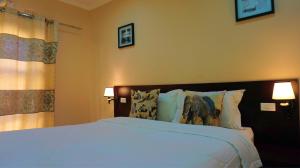 A bed or beds in a room at Tasha Lodge & Tours