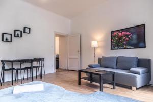 a living room with a couch and a table at Pleasant 2BR Apt- Near Train Station Hetzendorf in Vienna