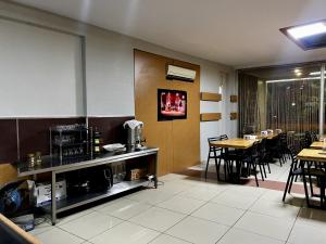 a dining room with tables and chairs in a restaurant at Otel Madi in Seyhan