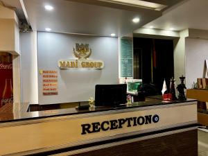 a restaurant with a counter with the words want group reception at Otel Madi in Seyhan