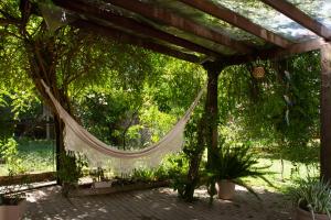 a hammock under a pergola in a garden at Casa Baseggio in Canela