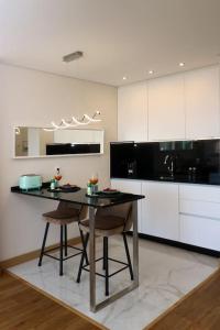 a kitchen with a table and two chairs in it at Vilamoura Sunrise in Quarteira