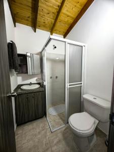 a bathroom with a shower and a toilet and a sink at Despertar Cafetero in Dosquebradas