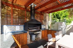 a outdoor kitchen with a wood fired oven at Owls Nest Self Catering in George
