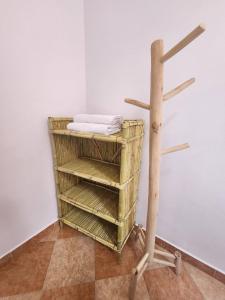a towel rack in a corner of a room with a towel rack at Winou Surf House in Aourir