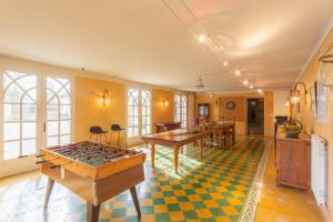 a living room with a table and ping pong tables at Domaine des sources - Welkeys in Orange +36 photos