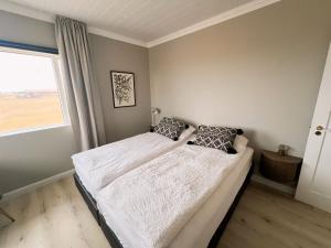 Cama o camas de una habitación en Garður Apartments