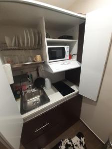 a small kitchen with a sink and a microwave at DramaMine1 in Drama