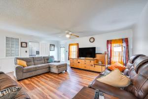a living room with a couch and a television at Greenville Home 2 Mi to Downtown! in Greenville