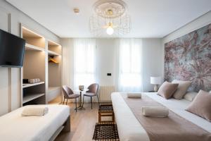 Postel nebo postele na pokoji v ubytování YOU & CO. J. Botánico Boutique