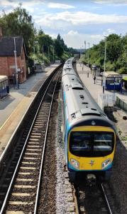 un treno giallo e blu che viaggia lungo i binari di Herbert - Duplex Relocations a Mexborough