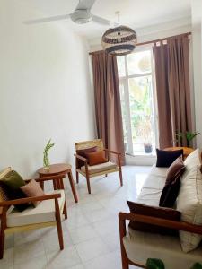 a living room with a couch and chairs and a window at Mount Bay Guest House in Mount Lavinia