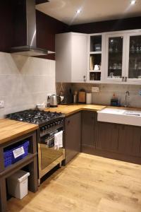 a kitchen with white cabinets and a stove top oven at Unique Highland in Inverness +10 photos