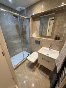 a bathroom with a shower and a sink at Seven Space 2 Bed 2 Bath Central Apartment in Norwich