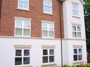 a red brick house with white windows at Hidden Gem in Manchester