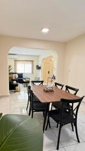 a dining room with a wooden table and chairs at Beautiful 3BR villa with Self-Check-in near to Major Events Family only in Jeddah