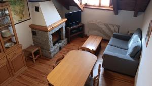 a living room with a couch and a fireplace at Lirio Pirenaico in Benasque