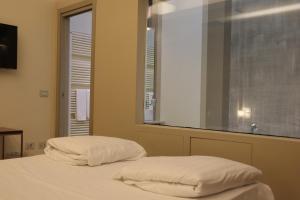 A bed or beds in a room at Borgo Santa Giulia