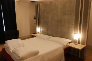A bed or beds in a room at Borgo Santa Giulia