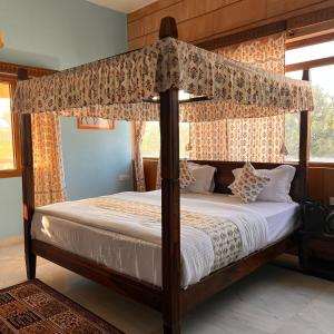 a bedroom with a four poster bed with a canopy at RAGHVENDRA HERITAGE in Jodhpur