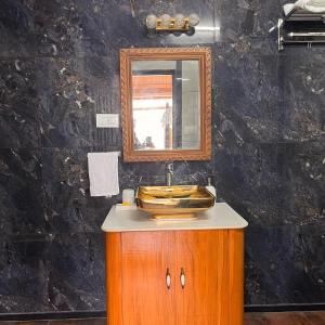 a bathroom with a sink and a mirror on a cabinet at RAGHVENDRA HERITAGE in Jodhpur