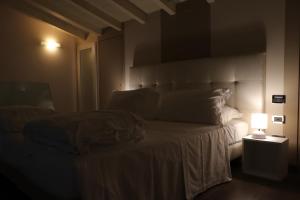 A bed or beds in a room at Borgo Santa Giulia