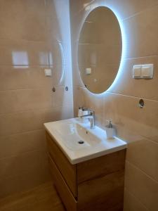 a bathroom with a sink and a mirror at Apartman Jadranka in Rab +60 photos