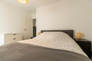 ein Schlafzimmer mit einem großen Bett mit zwei Nachttischen in der Unterkunft Appartement 70 m2 climatisé avec balcon et parking in Marseille